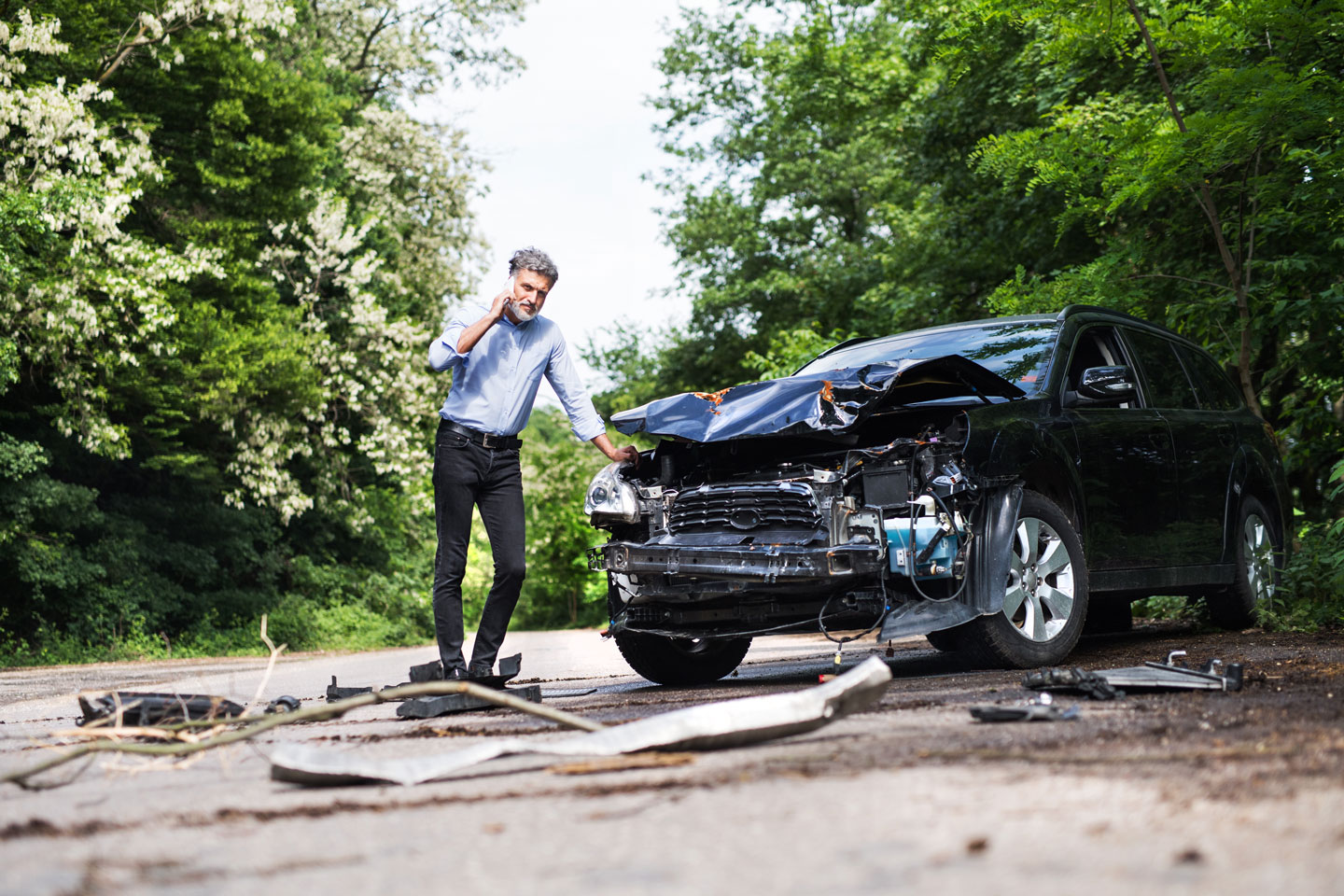 man standing by the car accident with injury