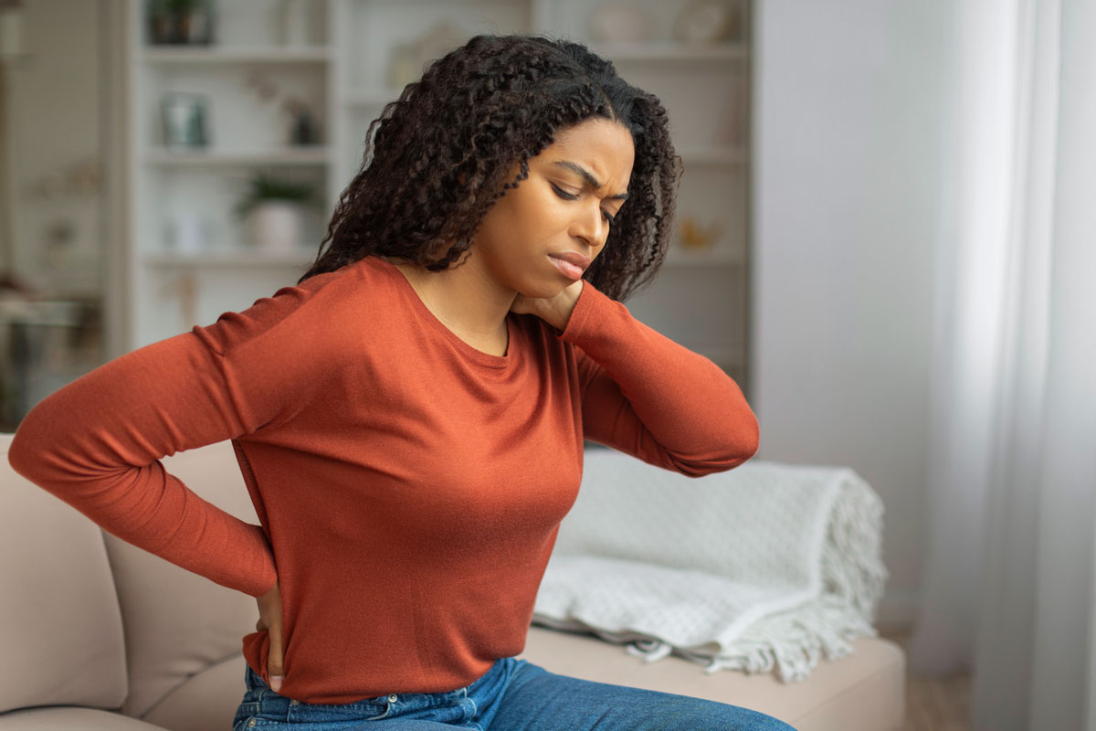 young black woman experiencing neck pain wants to improve well-being